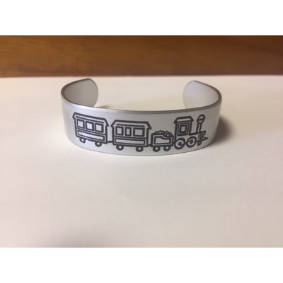 Aluminum cuff bracelet (5.5" x 1/2" wide) with a die struck, color filled imprint. Made in the USA